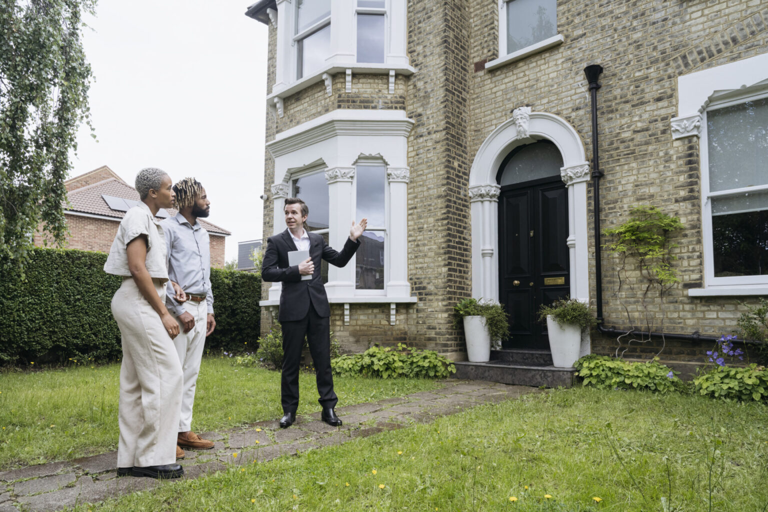 Estate agent describing house features to prospective buyers